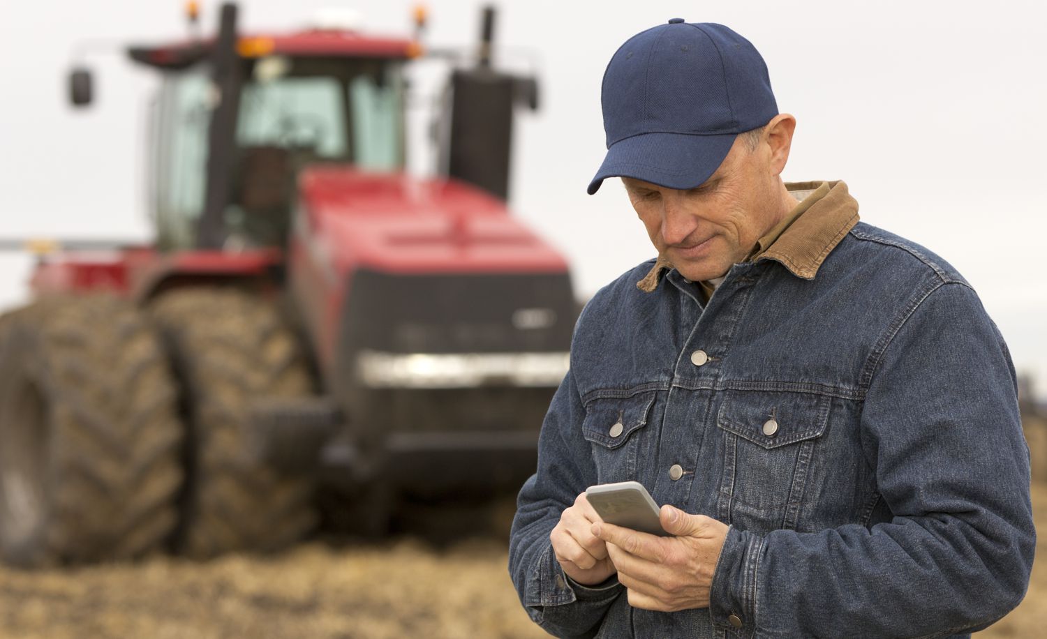Farmer with cell phone in field